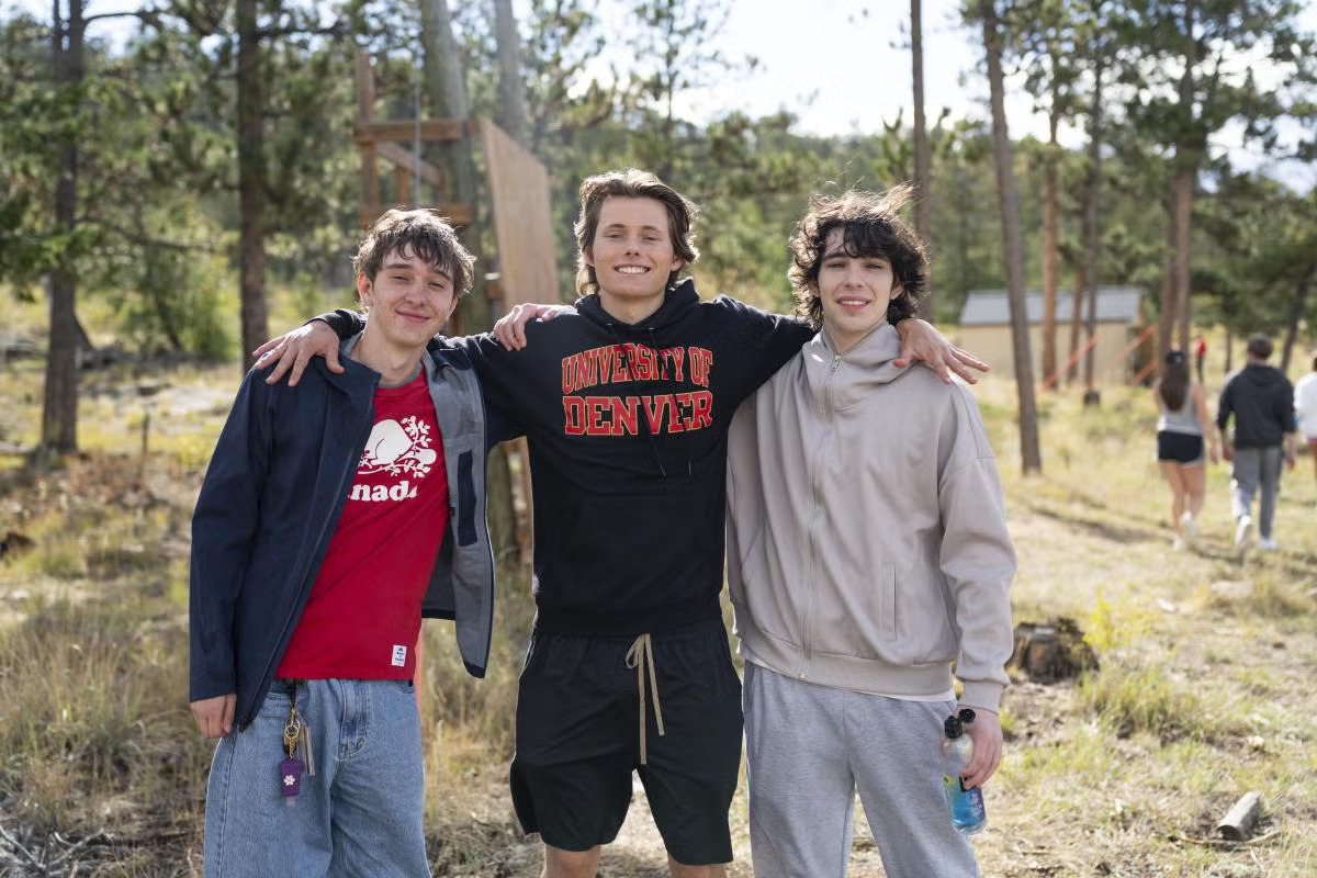 three male students pose during First Ascents weekend at KMC